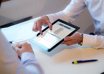 Patient reviewing dental insurance form on tablet