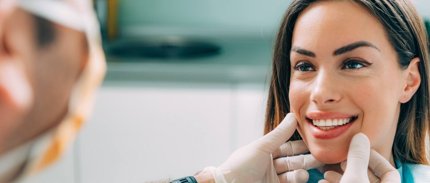 Woman smiling at her cosmetic dentist in Downers Grove