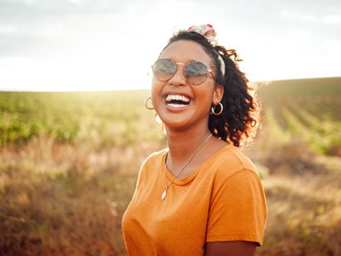 a smiling woman taking a walk outdoors