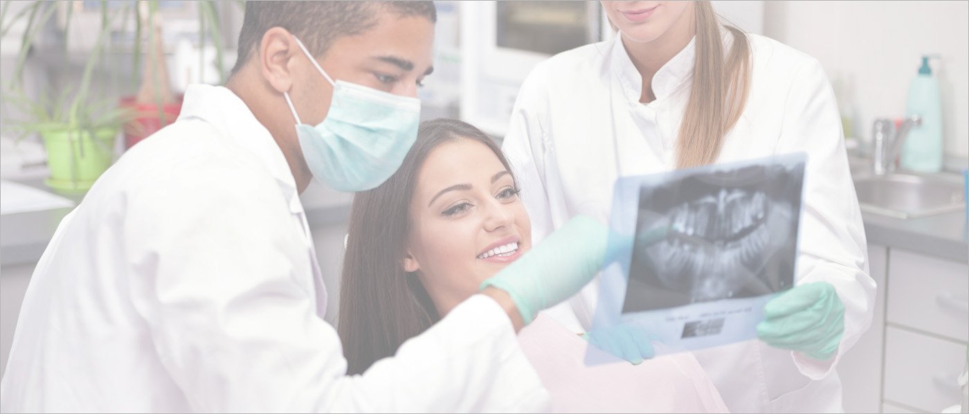 Two Downers Grove dentists showing x rays to a patient