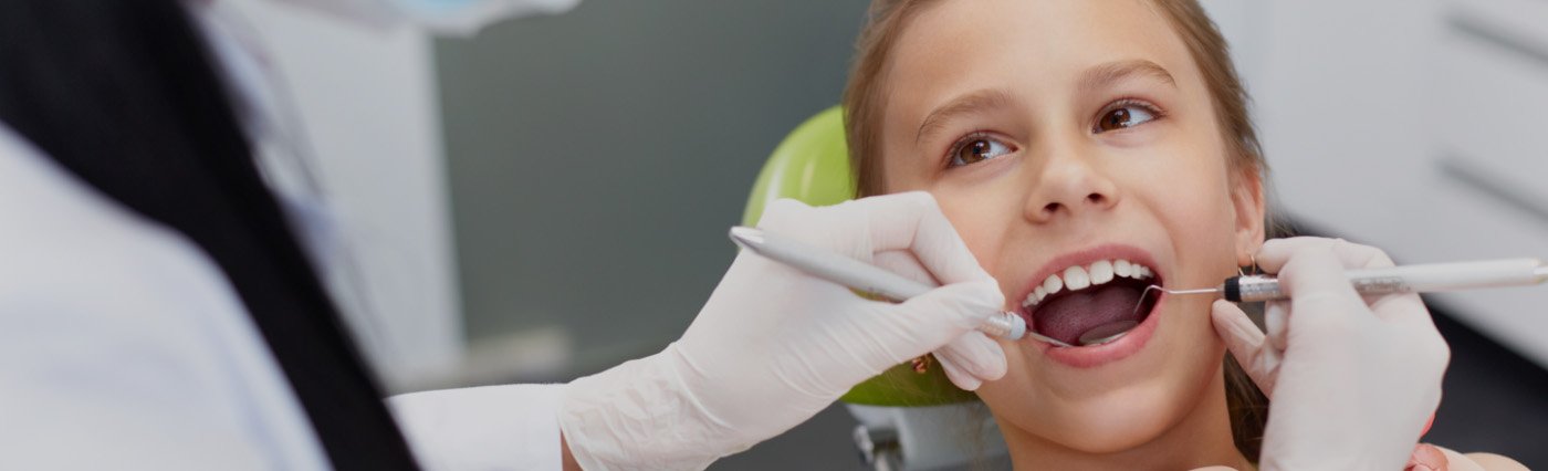 Child receiving dental treatment