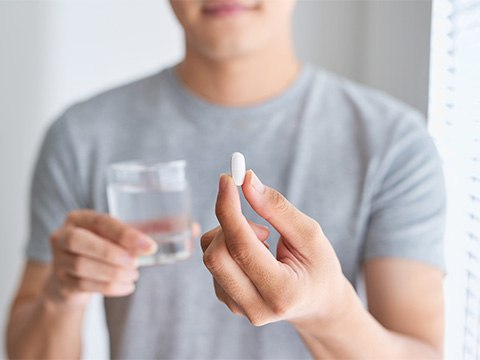 Patient holding oral sedative