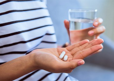 Patient holding oral sedatives in hand