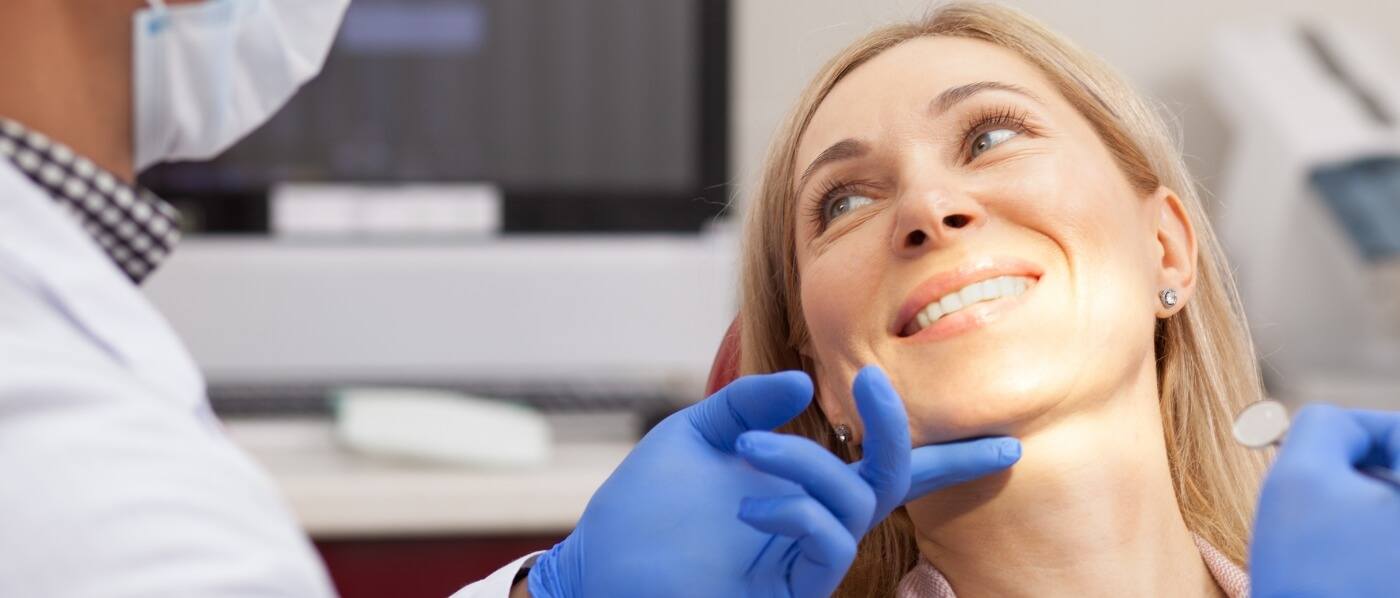 Woman smiling at her dentist during preventive dentistry visit