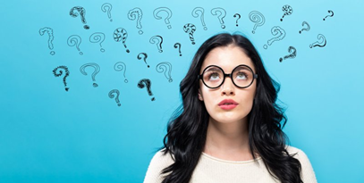 Woman looking up at several graphics of question marks