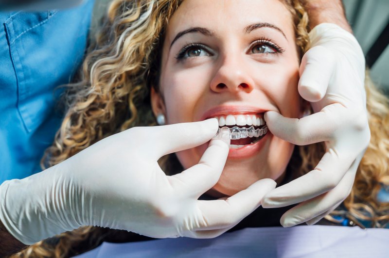 woman at dentist’s office with Invisalign 