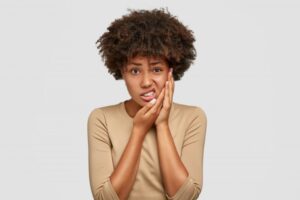 Woman experiencing a dental emergency